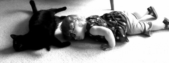Toddler Lounging with a Cat